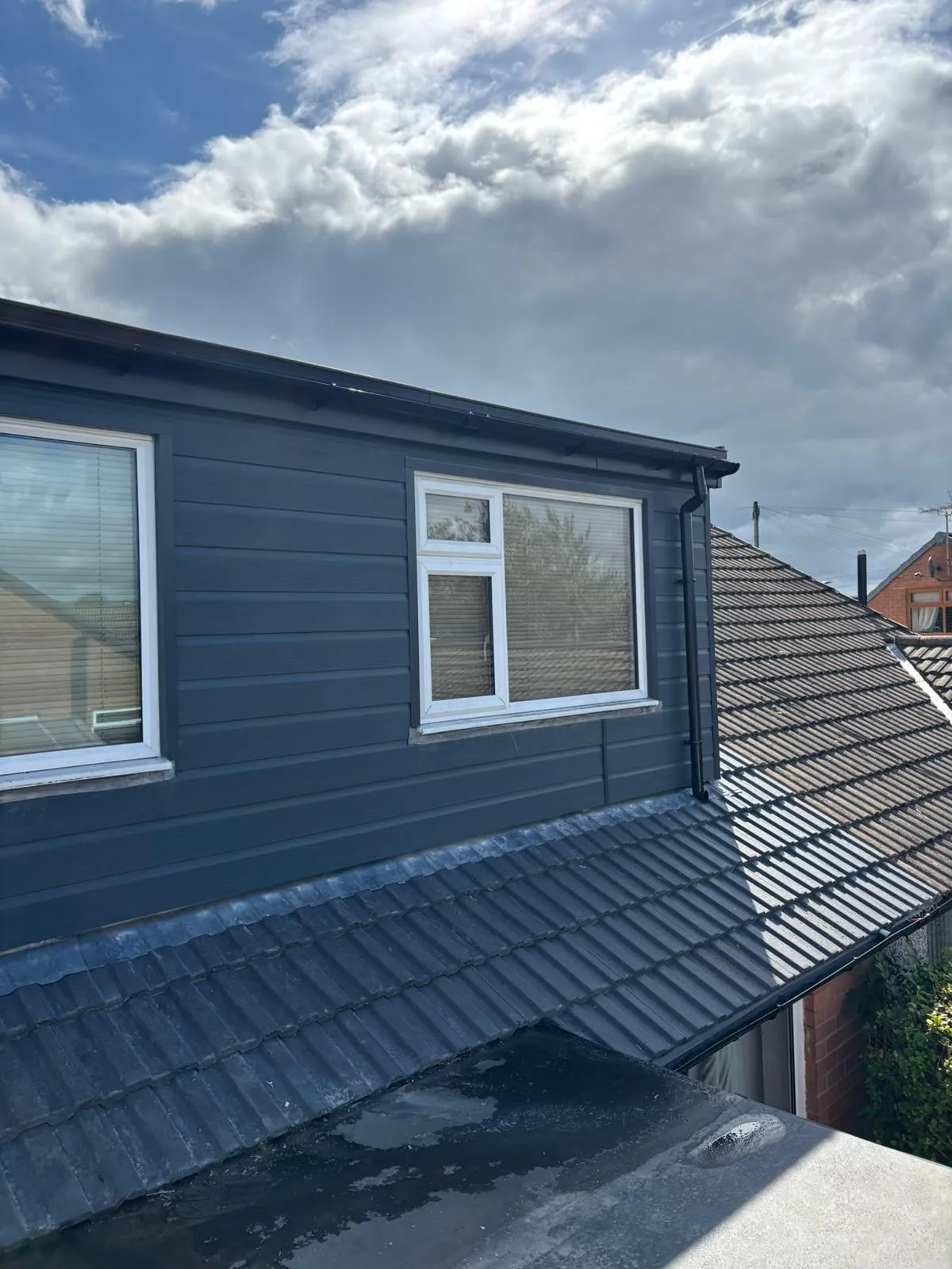 New grey cladding and roofline on a dormer by JRD Roofing